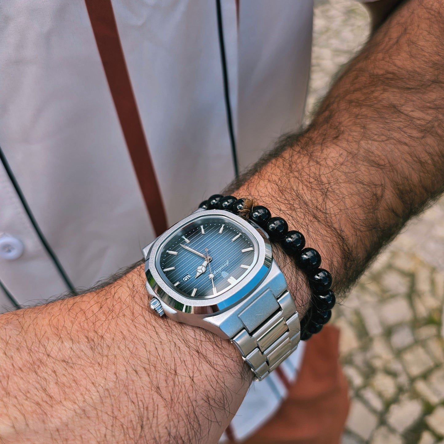 Front view of traditional men’s wristwatch with bold 40mm dial and minimalist quartz movement, worn with formal attire.