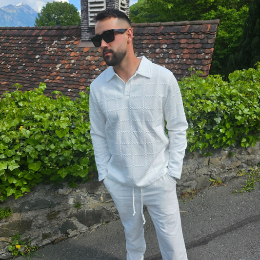 Full-body shot of man wearing all-white long sleeve polo and pants