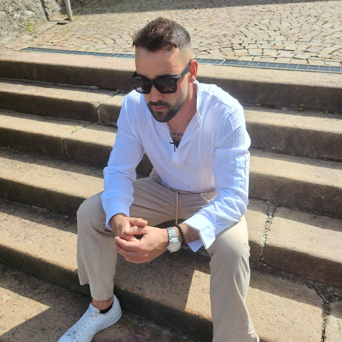 Side view of men's white linen Henley shirt showing split-sleeve cuff detail