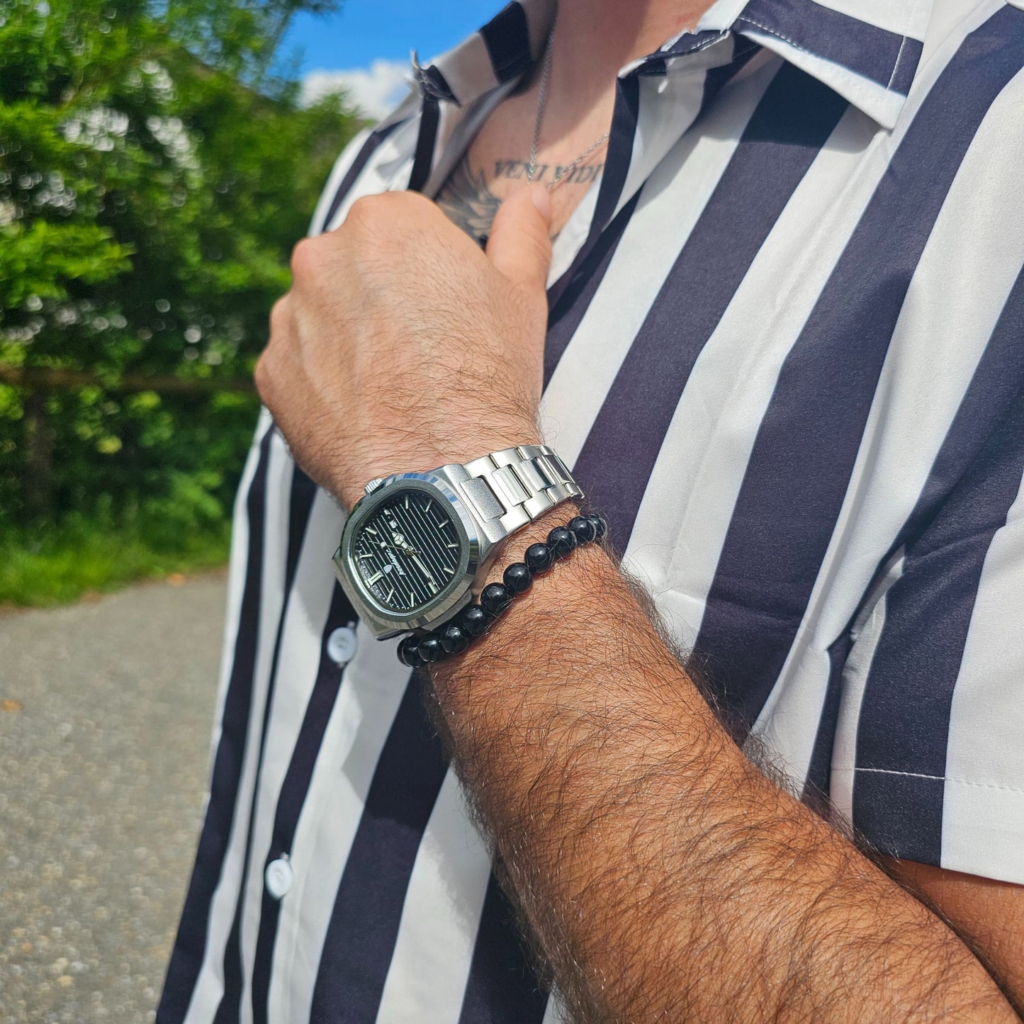 Luxury watch for men resting on a shirt symbolizing traditional values and quiet elegance.