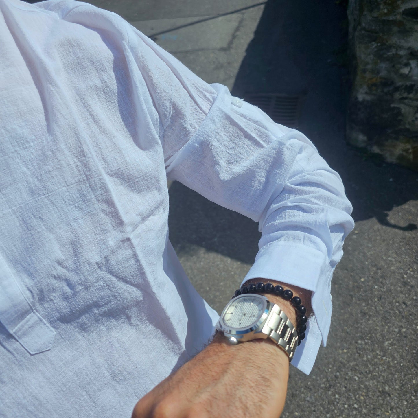 Men’s classic quartz watch displayed on wooden surface, representing durable, no-frills conservative design.