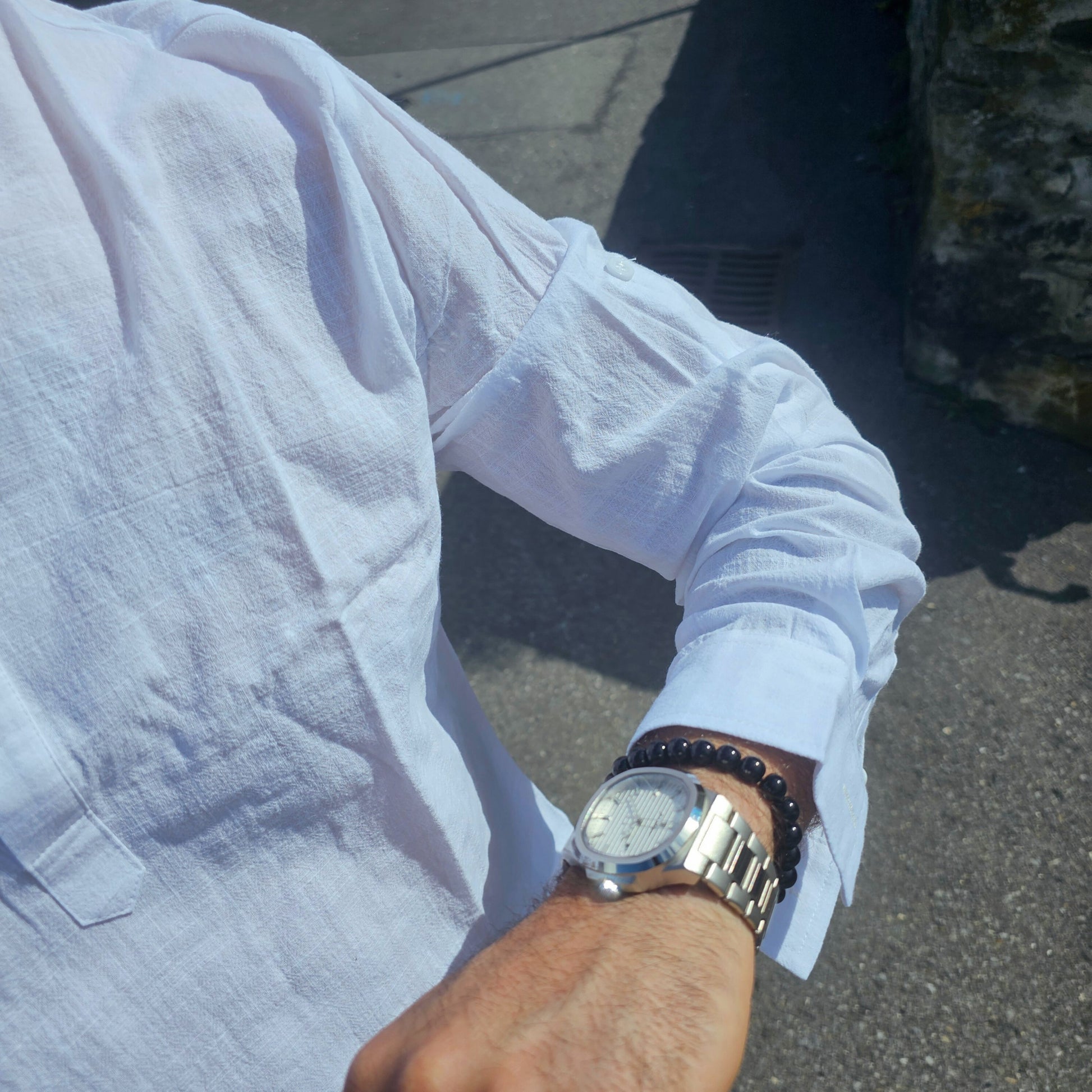Men’s classic quartz watch displayed on wooden surface, representing durable, no-frills conservative design.