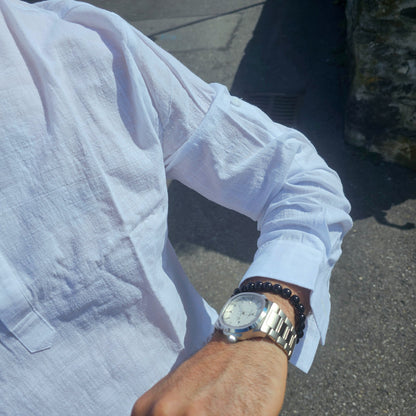 Men’s classic quartz watch displayed on wooden surface, representing durable, no-frills conservative design.