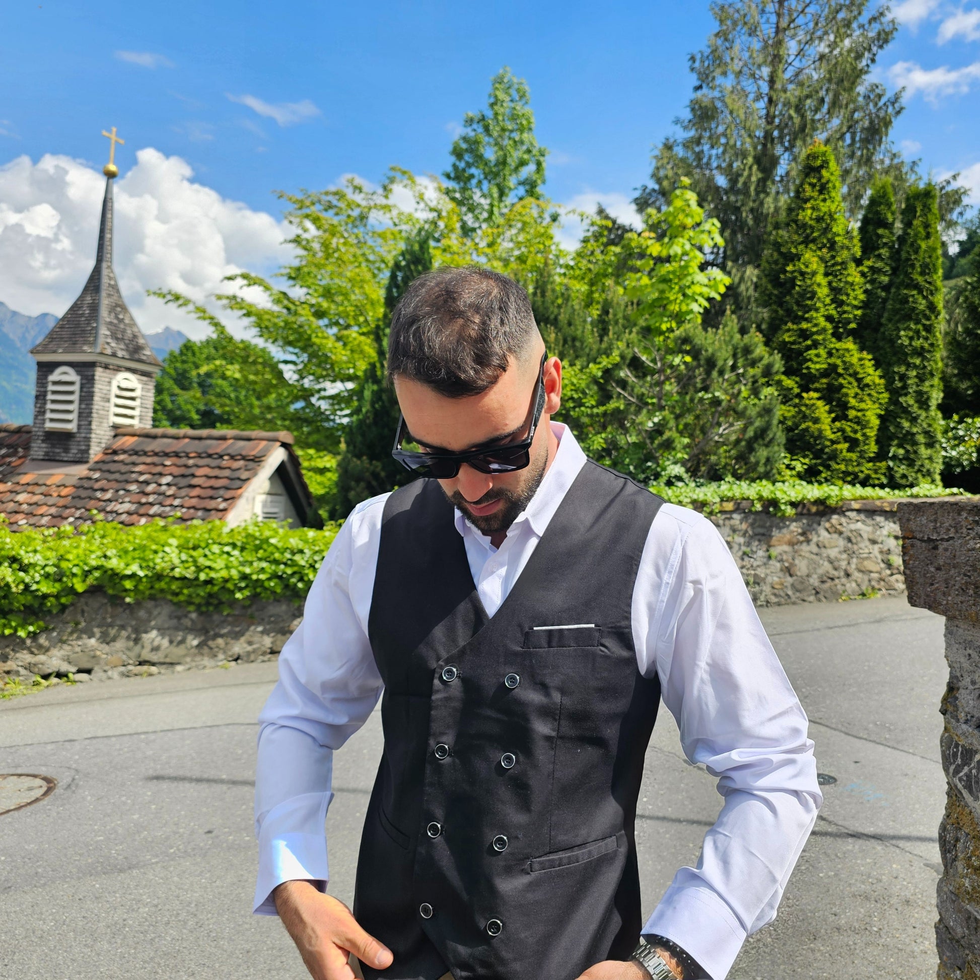 Model styling black sleeveless vest in a business-casual setting