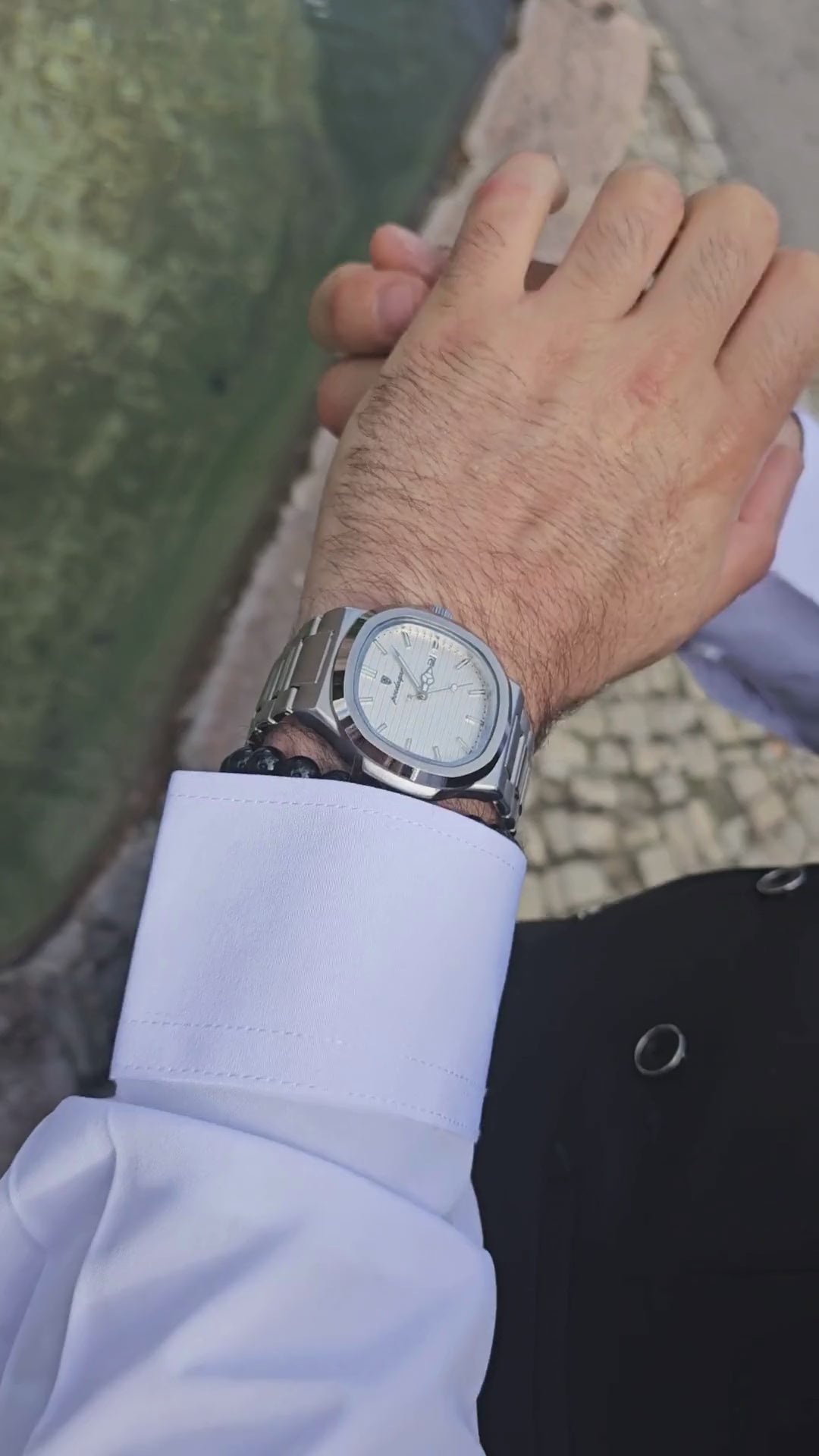 Side profile of stainless steel men’s dress watch highlighting the 10mm slim case and scratch-resistant Hardlex glass.